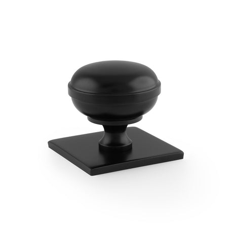 This is an image showing Alexander & Wilks Quantock Cupboard Knob on Square Backplate - Black - 34mm aw826-34-bl available to order from Trade Door Handles in Kendal, quick delivery and discounted prices.