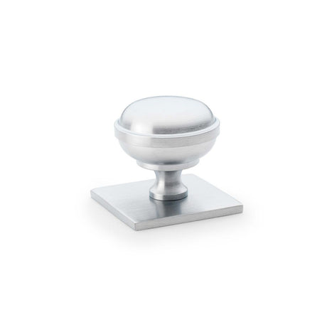 This is an image showing Alexander & Wilks Quantock Cupboard Knob on Square Backplate - Satin Chrome - 34mm aw826-34-sc available to order from Trade Door Handles in Kendal, quick delivery and discounted prices.