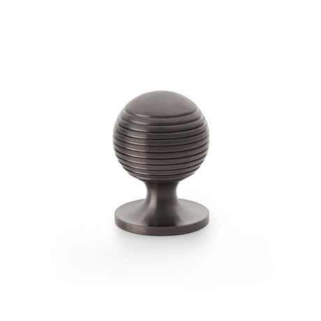 This is an image showing Alexander & Wilks Caesar Cupboard Knob on Round Rose - Dark Bronze PVD - 32mm aw832-32-dbzpvd available to order from Trade Door Handles in Kendal, quick delivery and discounted prices.