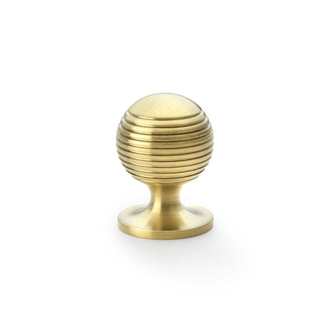This is an image showing Alexander & Wilks Caesar Cupboard Knob on Round Rose - Satin Brass PVD - 32mm aw832-32-sbpvd available to order from Trade Door Handles in Kendal, quick delivery and discounted prices.