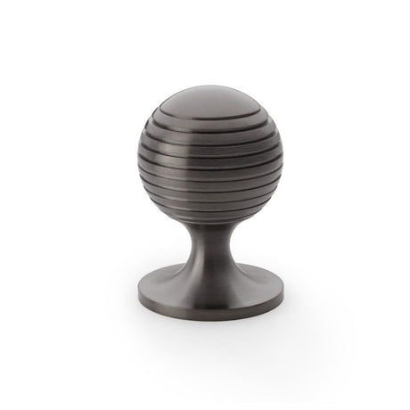 This is an image showing Alexander & Wilks Caesar Cupboard Knob on Round Rose - Dark Bronze PVD - 38mm aw832-38-dbzpvd available to order from Trade Door Handles in Kendal, quick delivery and discounted prices.