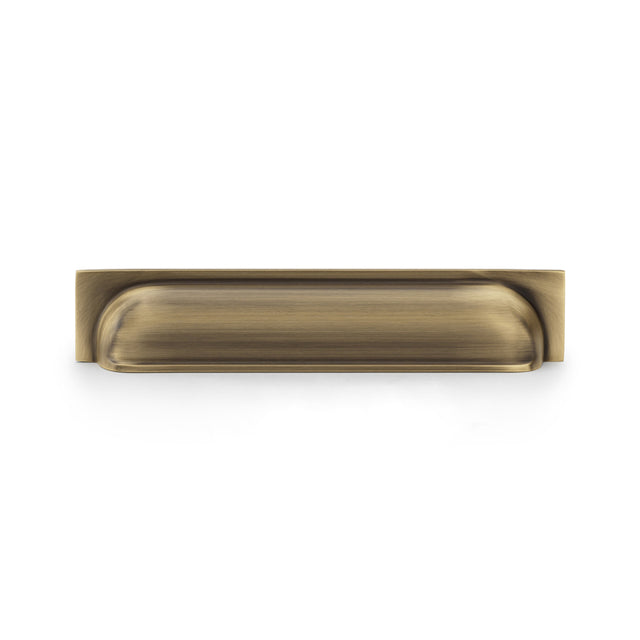 This is an image showing Alexander & Wilks Quantock Cup Pull Handle - Antique Brass - Centres 203mm aw906ab available to order from Trade Door Handles in Kendal, quick delivery and discounted prices.