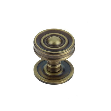 This is an image of a Burlington - Bloomury cupboard knob - Antique Brass  that is availble to order from Trade Door Handles in Kendal.