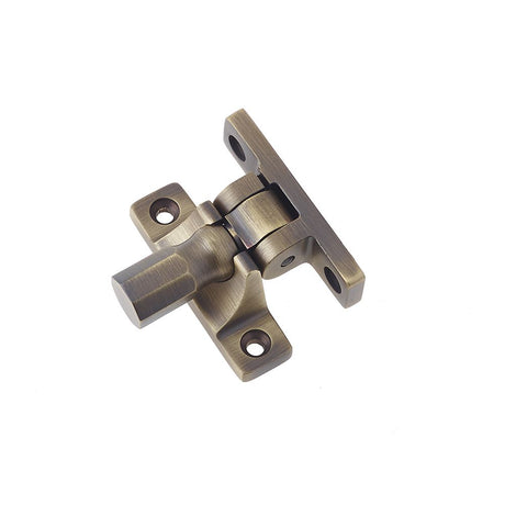 This is an image of a Burlington - Brighton sash fastener - Antique Brass  that is availble to order from Trade Door Handles in Kendal.