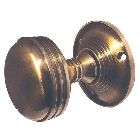 This is an image of a Frelan - Ringed Unsprung Mortice Knobs - Antique Brass  that is availble to order from Trade Door Handles in Kendal.