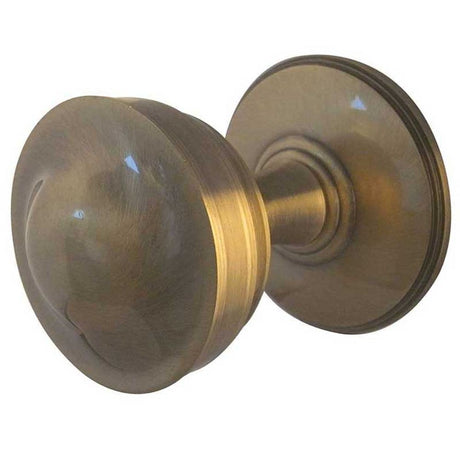 This is an image of a Frelan - Crown Unsprung Mortice Knobs - Antique Brass  that is availble to order from Trade Door Handles in Kendal.