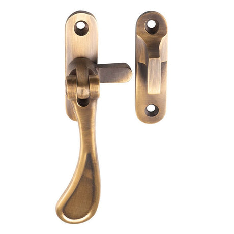 This is an image of a Carlisle Brass - Casement Fastener Reversible - Antique Brass that is availble to order from Trade Door Handles in Kendal.