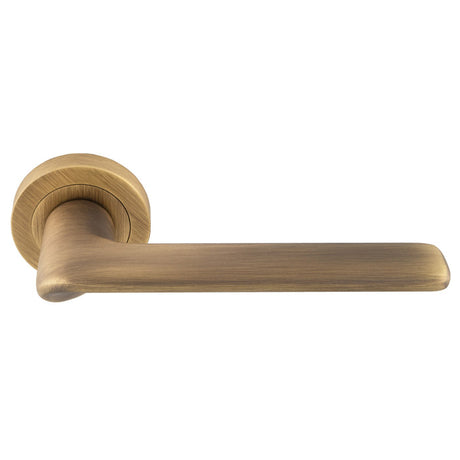 This is an image of a Manital - Vortex lever on rose - Antique Brass vx5ab that is availble to order from Trade Door Handles in Kendal.