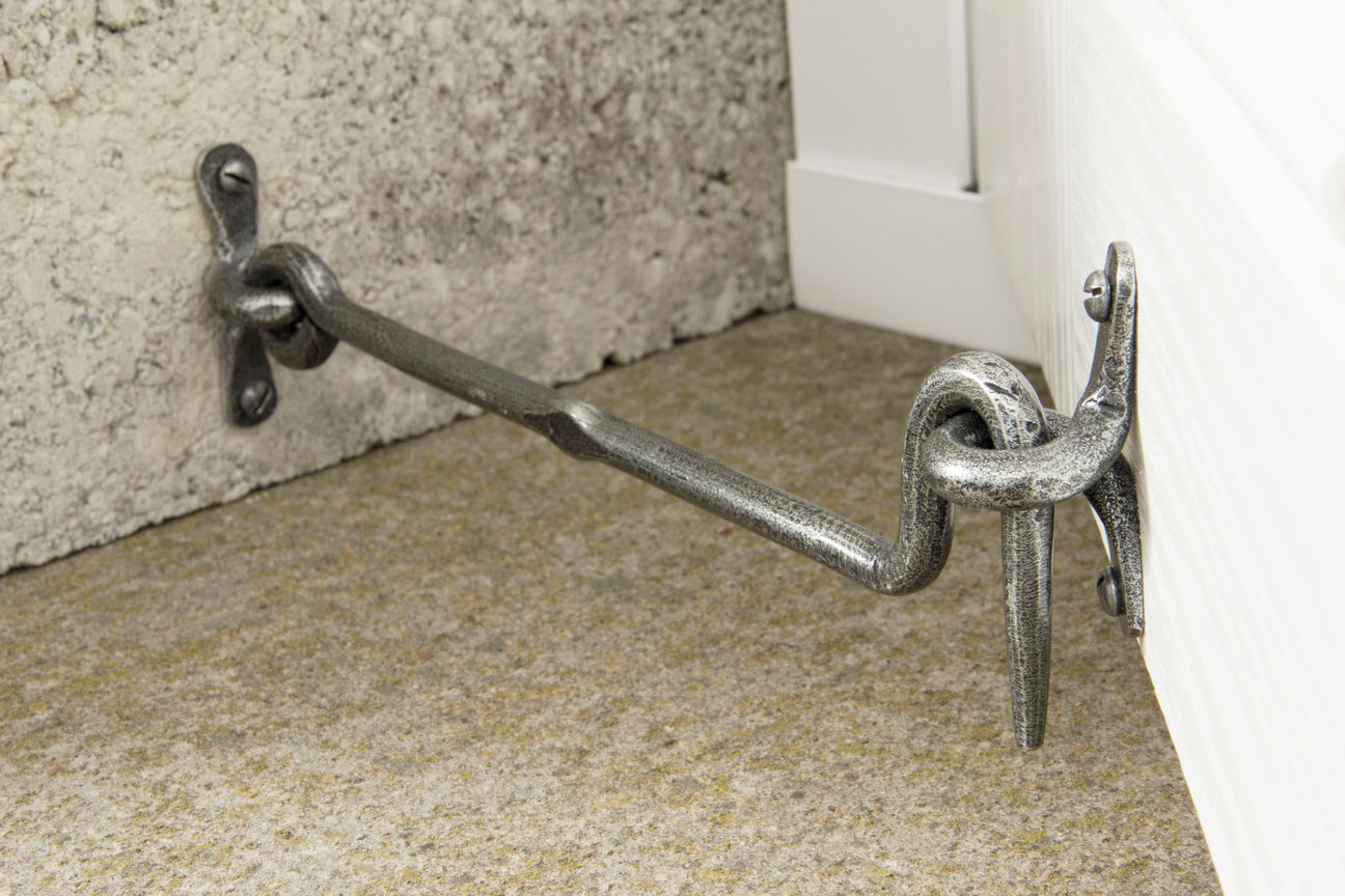 From The Anvil Pewter Cabin Hook holding a door open