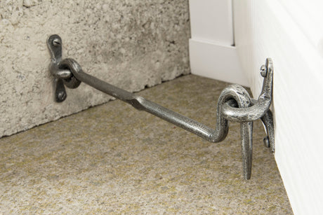 From The Anvil Pewter Cabin Hook holding a door open