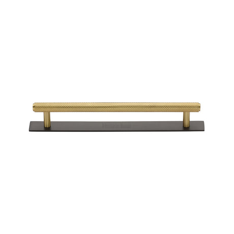 Knurled cabinet pull on plate in matt bronze and satin brass