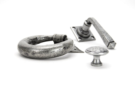 Image showing a door knocker, door handle and a cabinet handle in Pewter Patina made by From The Anvil.  Available from Trade Door Handles in Kendal