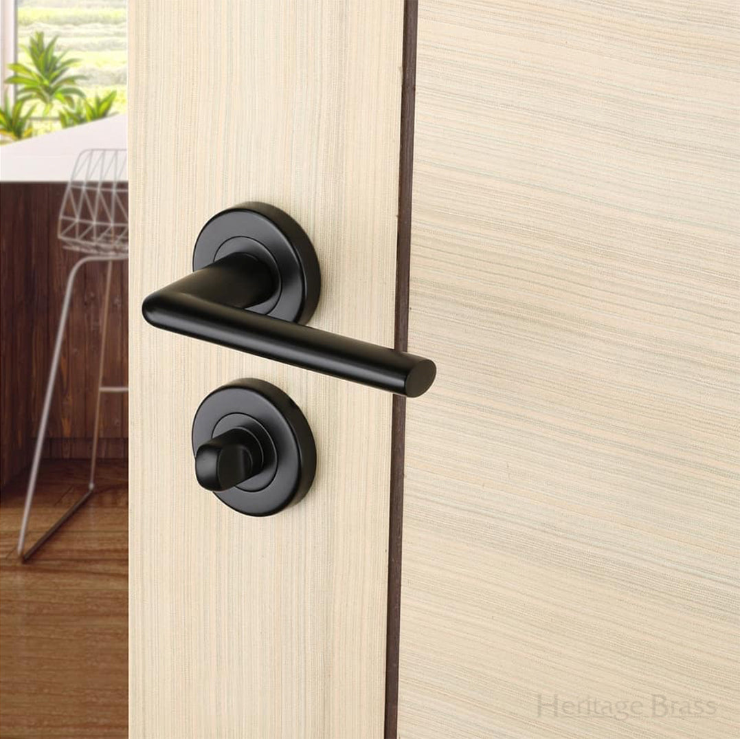 Sorrento Black Door Handle on round rose with a bathroom turn below the handles SKU. SC-2352-BLK