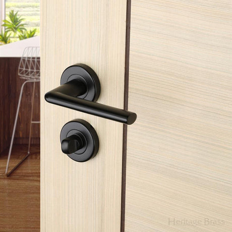 Sorrento Black Door Handle on round rose with a bathroom turn below the handles SKU. SC-2352-BLK