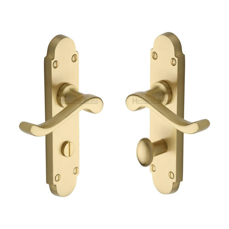 Satin brass bathroom door handle on backplate