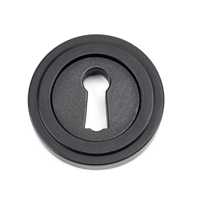 From The Anvil - Matt Black Round Escutcheon (Art Deco) | Sku. 49537 | Trade Door Handles.