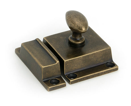 This is an image of From The Anvil - Burnished Brass Cabinet Latch available to order from Trade Door Handles in Kendal.