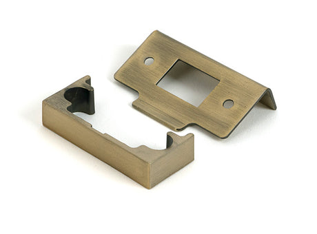 This is an image of From The Anvil - Aged Brass Â½" Rebate Kit for Tubular Mortice Latch available to order from Trade Door Handles in Kendal.