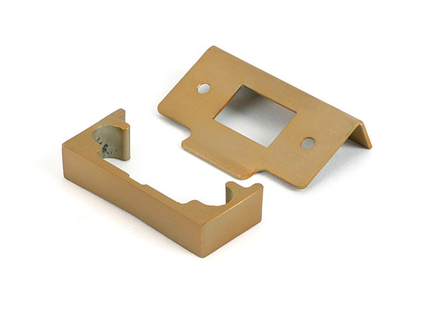 This is an image of From The Anvil - Satin Brass Â½" Rebate Kit for Tubular Mortice Latch available to order from Trade Door Handles in Kendal.