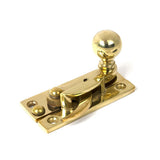High quality images of the From The Anvil - Polished Brass Sash Hook Fastener | Sku. Anvil-52369 | available to order from Trade Door Handles, quick delivery at discounted prices.