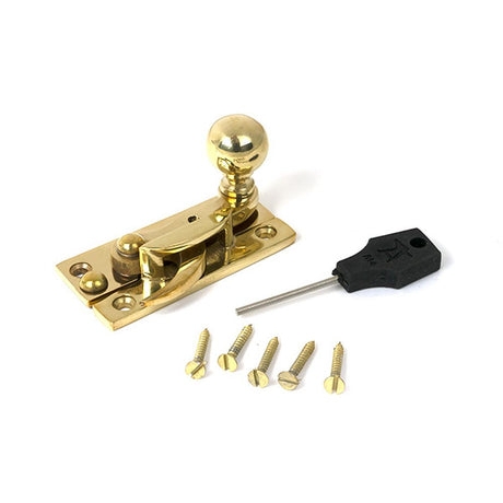 High quality images of the From The Anvil - Polished Brass Sash Hook Fastener | Sku. Anvil-52369 | available to order from Trade Door Handles, quick delivery at discounted prices.