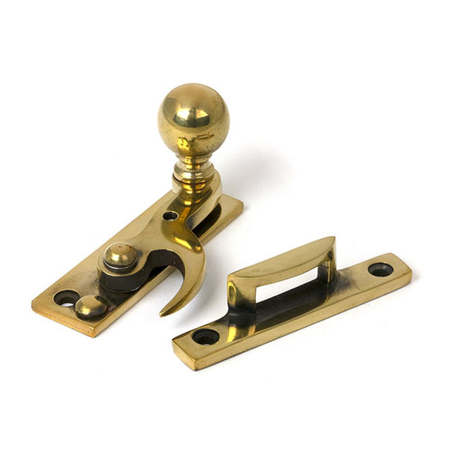 High quality images of the From The Anvil - Aged Brass Sash Hook Fastener | Sku. Anvil-52370 | available to order from Trade Door Handles, quick delivery at discounted prices.