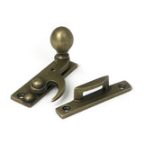High quality images of the From The Anvil - Burnished Brass Sash Hook Fastener | Sku. Anvil-52376 | available to order from Trade Door Handles, quick delivery at discounted prices.