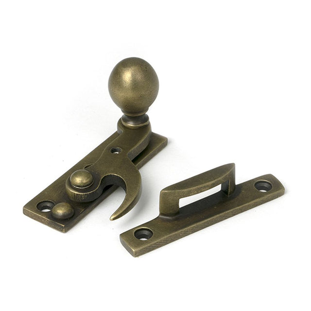 High quality images of the From The Anvil - Burnished Brass Sash Hook Fastener | Sku. Anvil-52376 | available to order from Trade Door Handles, quick delivery at discounted prices.