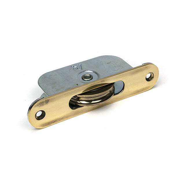 High quality images of the From The Anvil - Aged Brass Radiused Sash Pulley 75kg | Sku. Anvil-52395 | available to order from Trade Door Handles, quick delivery at discounted prices.