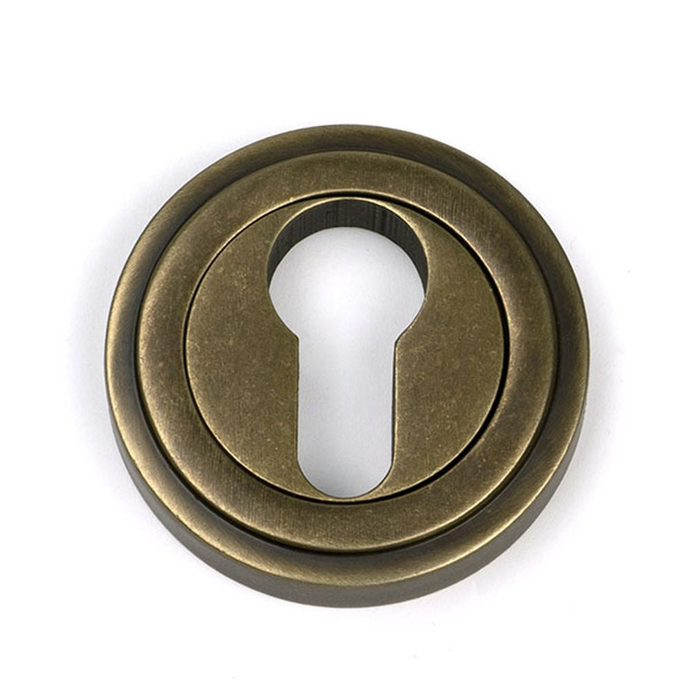 High quality images of the From The Anvil - Burnished Brass Round Euro Escutcheon (Art Deco) | Sku. Anvil-52448 | available to order from Trade Door Handles, quick delivery at discounted prices.