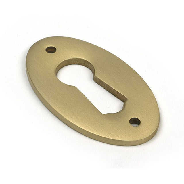 High quality images of the From The Anvil - Satin Brass Oval Escutcheon | Sku. Anvil-52456 | available to order from Trade Door Handles, quick delivery at discounted prices.