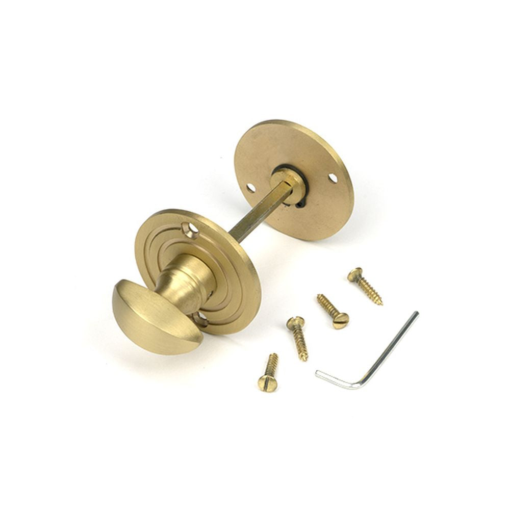 High quality images of the From The Anvil - Satin Brass Round Bathroom Thumbturn | Sku. Anvil-52463 | available to order from Trade Door Handles, quick delivery at discounted prices.
