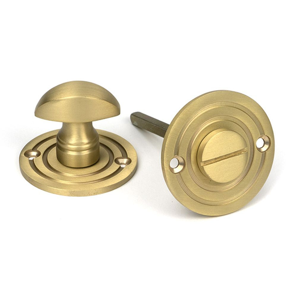 High quality images of the From The Anvil - Satin Brass Round Bathroom Thumbturn | Sku. Anvil-52463 | available to order from Trade Door Handles, quick delivery at discounted prices.