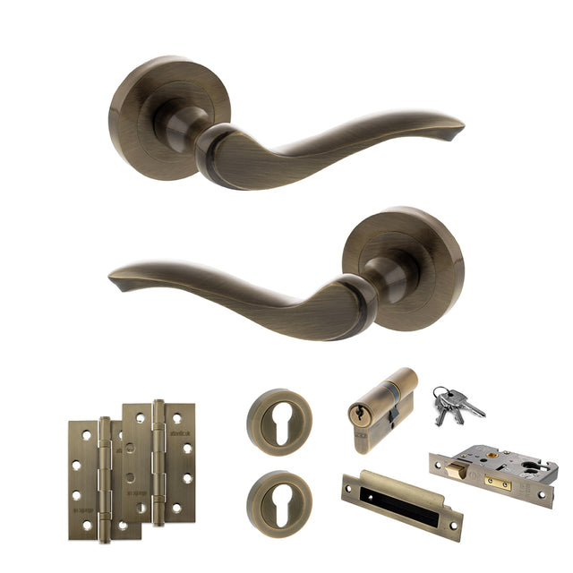 Quality image of Old English Warwick Door Handle Pack (Euro Lock Set - 2.5" CE Sashlock, 4" Slim Knuckle Hinges x2) - Antique Brass | Sku. adpoe178ab24 | available from Trade Door Handles.