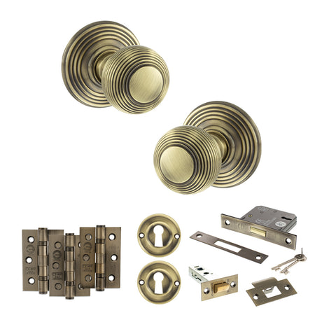 Quality image of Old English Ripon Door Knob Pack (Lock Set - 3" Latch & Deadlock, 3" Fire Rated Hinges x3) - Antique Brass | Sku. adpoe50rmkab66 | available from Trade Door Handles.