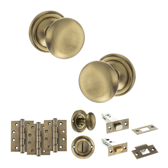 Quality image of Old English Harrogate Door Knob Pack (Bathroom Set - 4" Deadbolt, 4" Fire Rated Hinges x3) - Antique Brass | Sku. adpoe58mmkab63 | available from Trade Door Handles.