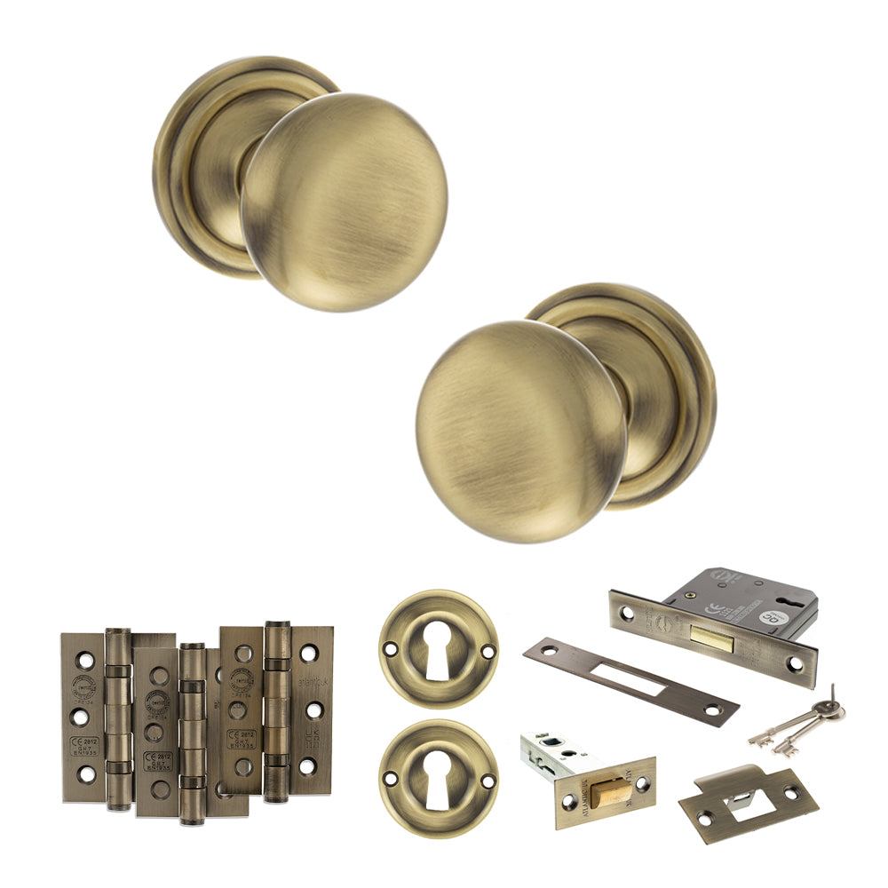 Quality image of Old English Harrogate Door Knob Pack (Lock Set - 3" Latch & Deadlock, 3" Fire Rated Hinges x3) - Antique Brass | Sku. adpoe58mmkab66 | available from Trade Door Handles.