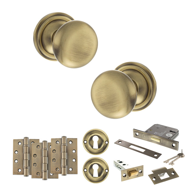 Quality image of Old English Harrogate Door Knob Pack (Lock Set - 3" Latch & Deadlock, 4" Fire Rated Hinges x3) - Antique Brass | Sku. adpoe58mmkab67 | available from Trade Door Handles.