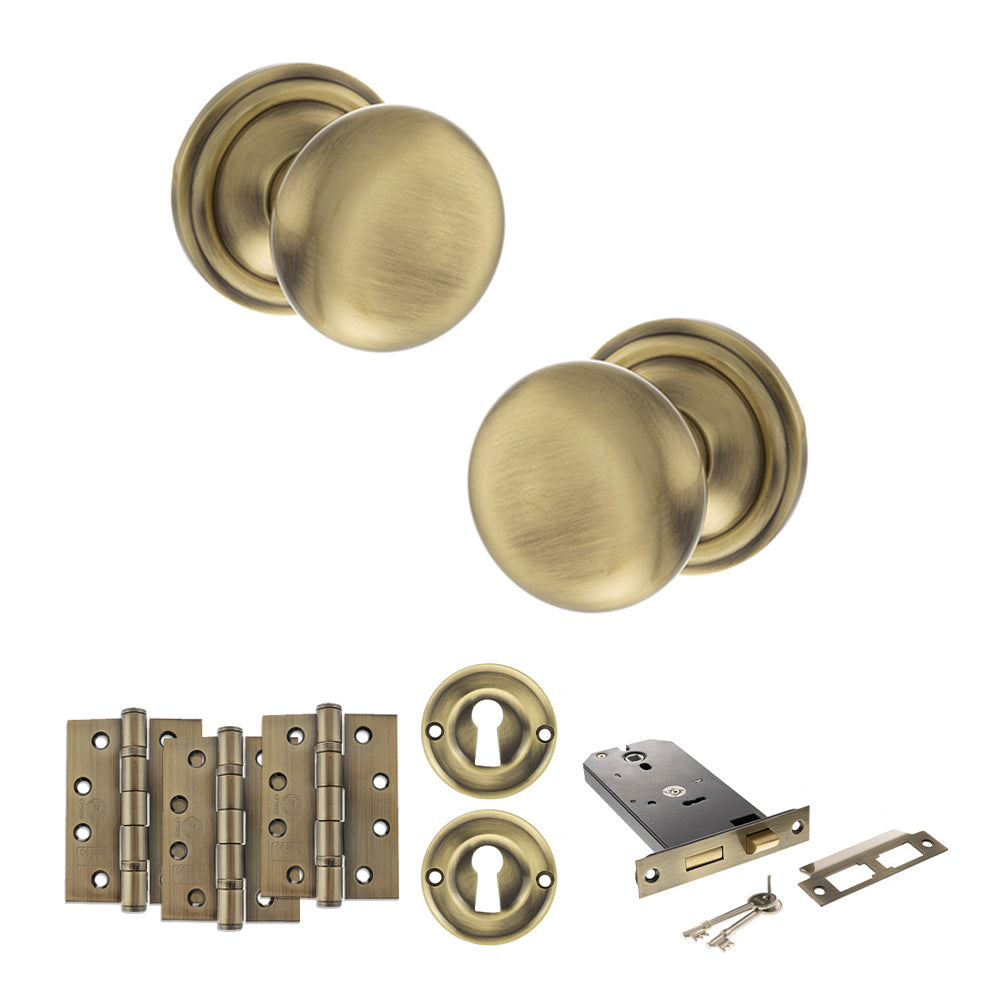 Quality image of Old English Harrogate Door Knob Pack (Lock Set - Horizontal Sashlock, 4" Fire Rated Hinges x3) - Antique Brass | Sku. adpoe58mmkab71 | available from Trade Door Handles.