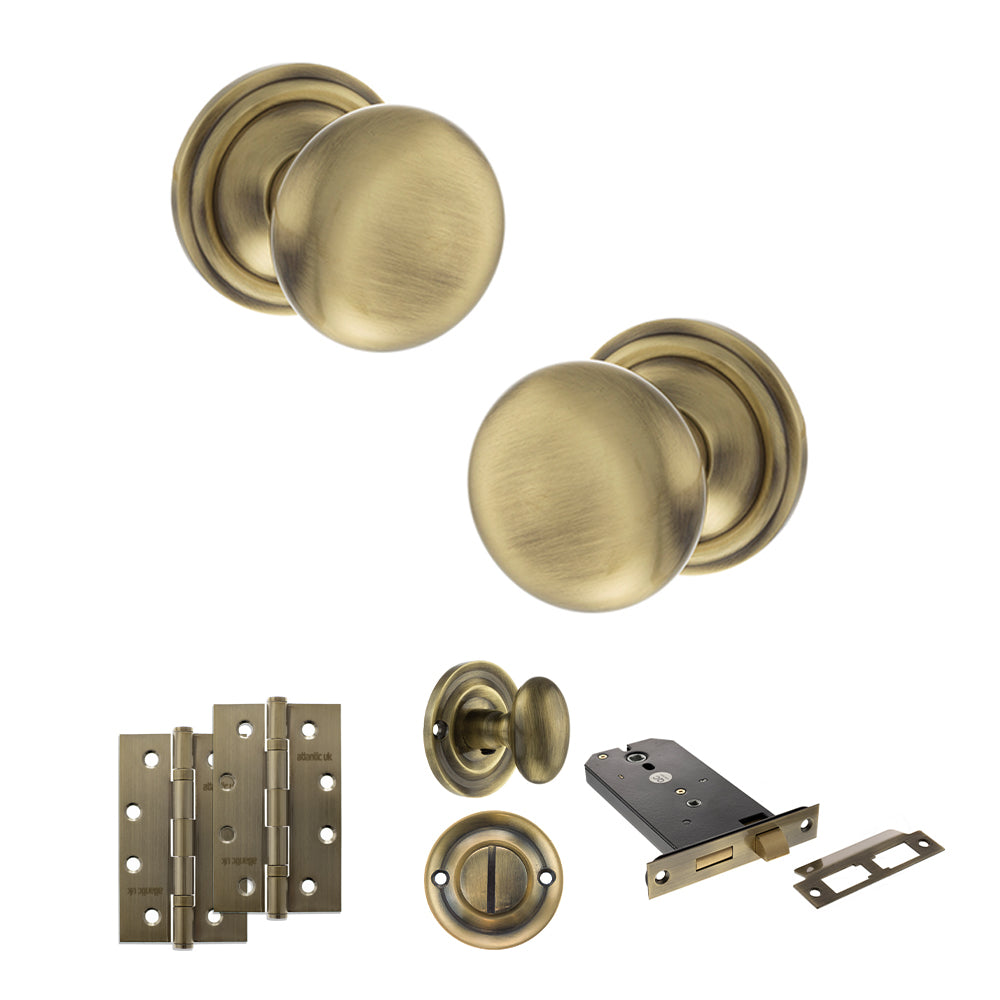 Quality image of Old English Harrogate Door Knob Pack (Lock Set - Horizontal Bathlock, 4" Slim Knuckle Hinges x2) - Antique Brass | Sku. adpoe58mmkab74 | available from Trade Door Handles.