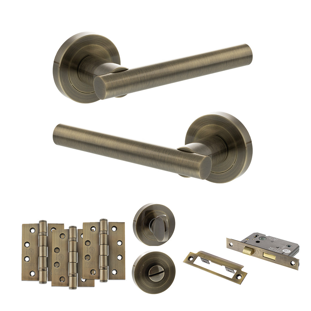 Quality image of STATUS Nebraska Door Handle Pack (Bathroom Set - 3" CE Bathroom Lock, 4" Fire Rated Hinges x3) - Antique Brass | Sku. adps28rab11 | available from Trade Door Handles.
