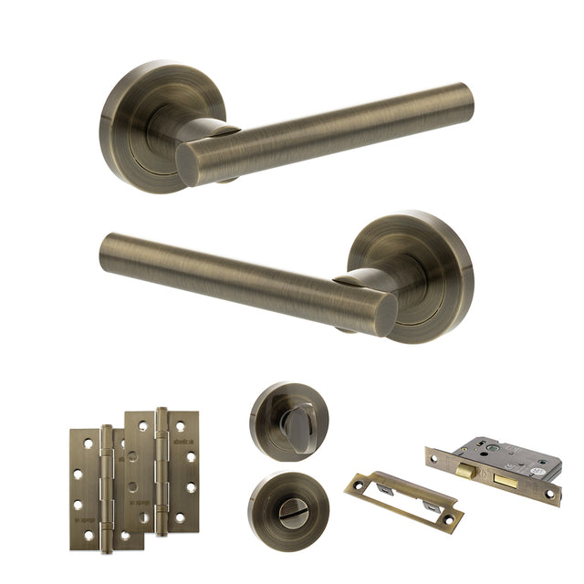 Quality image of STATUS Nebraska Door Handle Pack (Bathroom Set - 2.5" CE Bathroom Lock, 4" Slim Knuckle Hinges x2) - Antique Brass | Sku. adps28rab12 | available from Trade Door Handles.
