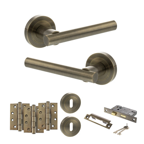 Quality image of STATUS Nebraska Door Handle Pack (3 Lever Lock Set - 3" CE Sashlock, 4" Fire Rated Hinges x3) - Antique Brass | Sku. adps28rab17 | available from Trade Door Handles.