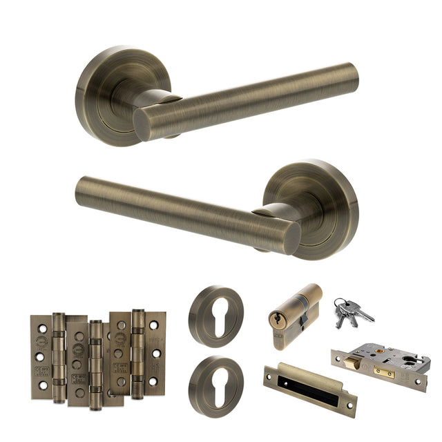 Quality image of STATUS Nebraska Door Handle Pack (Euro Lock Set - 3" CE Sashlock, 3" Fire Rated Hinges x3) - Antique Brass | Sku. adps28rab21 | available from Trade Door Handles.