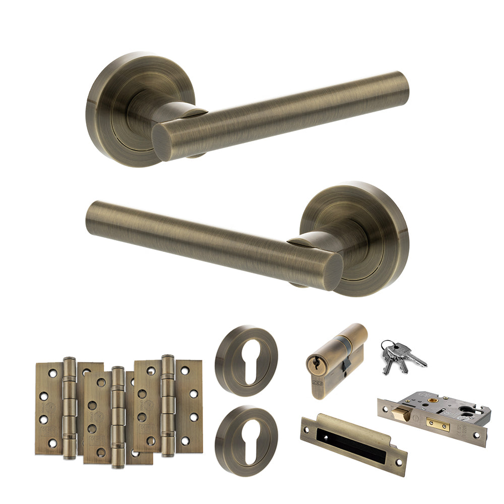 Quality image of STATUS Nebraska Door Handle Pack (Euro Lock Set - 3" CE Sashlock, 4" Fire Rated Hinges x3) - Antique Brass | Sku. adps28rab23 | available from Trade Door Handles.