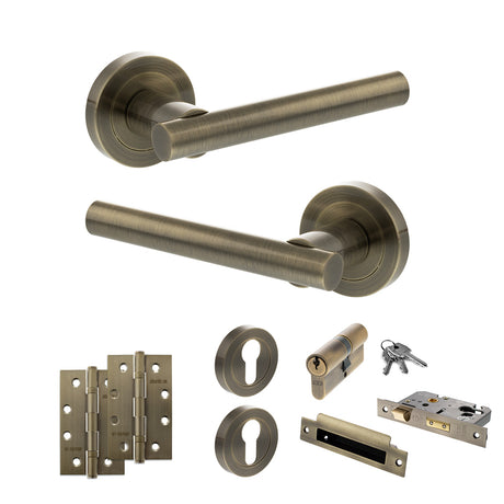 Quality image of STATUS Nebraska Door Handle Pack (Euro Lock Set - 2.5" CE Sashlock, 4" Slim Knuckle Hinges x2) - Antique Brass | Sku. adps28rab24 | available from Trade Door Handles.