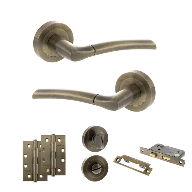 Quality image of STATUS Indiana Door Handle Pack (Bathroom Set - 2.5" CE Bathroom Lock, 4" Slim Knuckle Hinges x2) - Antique Brass | Sku. adps33rab12 | available from Trade Door Handles.