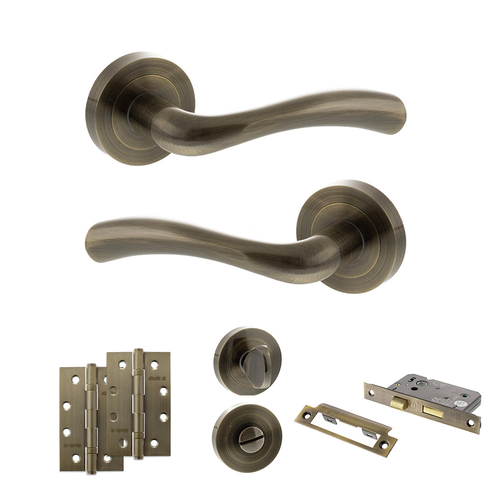 Quality image of STATUS Texas Door Handle Pack (Bathroom Set - 2.5" CE Bathroom Lock, 4" Slim Knuckle Hinges x2) - Antique Brass | Sku. adps35rab12 | available from Trade Door Handles.
