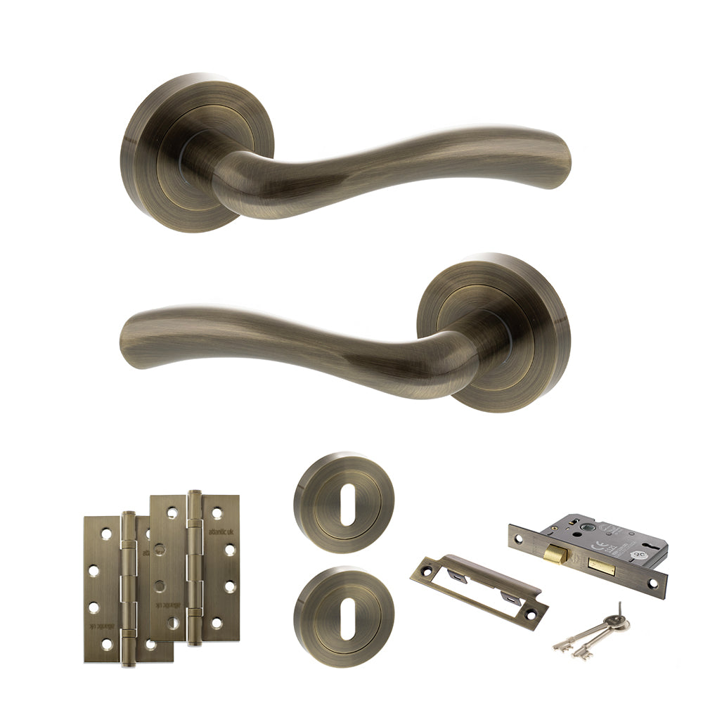 Quality image of STATUS Texas Door Handle Pack (3 Lever Lock Set - 3" CE Sashlock, 4" Slim Knuckle Hinges x2) - Antique Brass | Sku. adps35rab19 | available from Trade Door Handles.