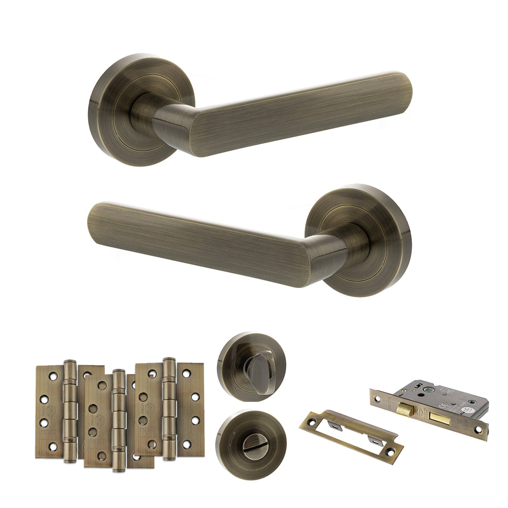 Quality image of STATUS Carolina Door Handle Pack (Bathroom Set - 3" CE Bathroom Lock, 4" Fire Rated Hinges x3) - Antique Brass | Sku. adps42rab11 | available from Trade Door Handles.
